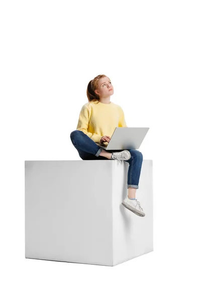 Full-length portrait of young girl, concentrated student working on study project isolated over white background — Stock Photo, Image
