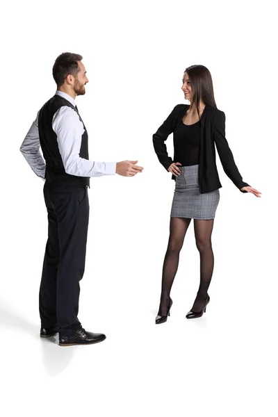 Full-length portrait of man and woman, employees communicating, arguing isolated over white background — стоковое фото