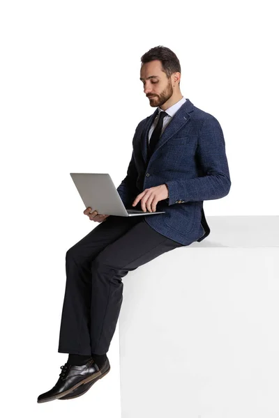 Full-length portrait of businessman, employee, office worker typing on laptop, working on new project isolated over white background — Fotografia de Stock