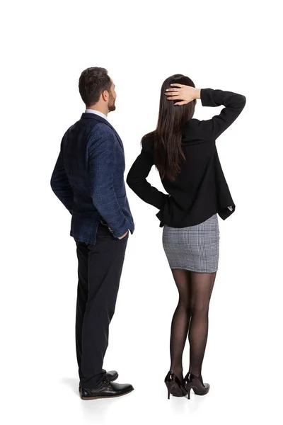 Full-length back view portrait of two office workers looking on board isolated over white background — Stok fotoğraf