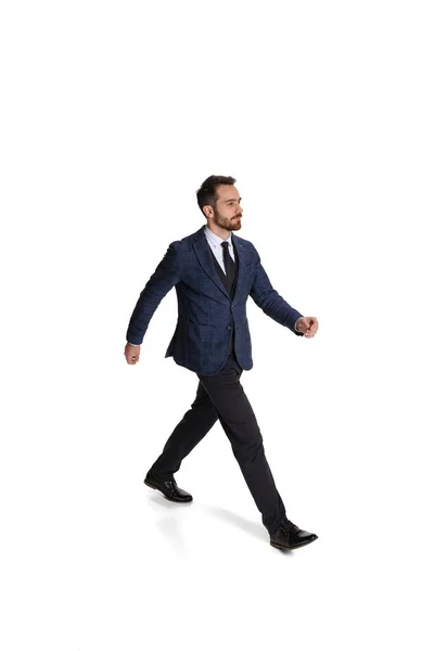 Full-length portrait of businessman, office worker, employee walking towards isolated over white background — Photo