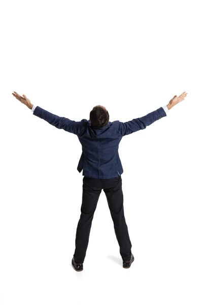 Back view portrait of man, office worker standing in happy and excited pose celebrating success isolated over white background — Stockfoto