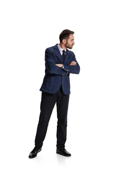 Full-length portrait of businessman with curious and concentrated facial expression controlling projects isolated over white background — Zdjęcie stockowe