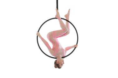 Portrait of young sportive girl, air gymnast performing on hoop isolated over white studio background