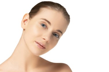 Beyaz stüdyo arkaplanından izole edilmiş kameraya bakan temiz tenli güzel bir kadının yakın plan portresi. Deri tedavisi