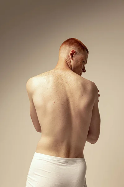 年轻肌肉发达的红头发男子的半身像 有质感的背 模特穿着内衣在灰色的工作室背景下进行隔离 男子健康 身体和皮肤护理的概念 — 图库照片