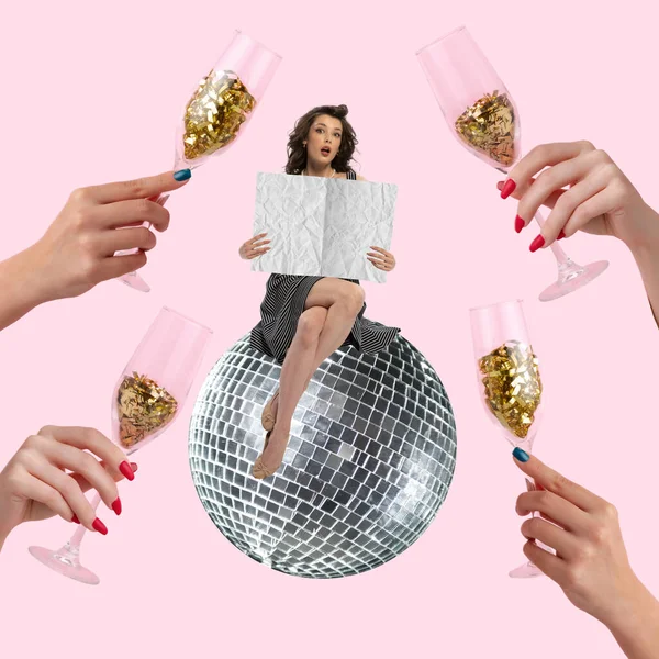 Contemporary art collage. Beautiful stylish young girl sitting on big disco ball and reading birthday invitation isolated over pink background. Champagne glasses filled with confetti. Colorful design