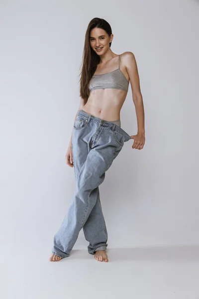 Portrait Beautiful Young Woman Posing Big Jeans Cotton Top Isolated — Stock Photo, Image
