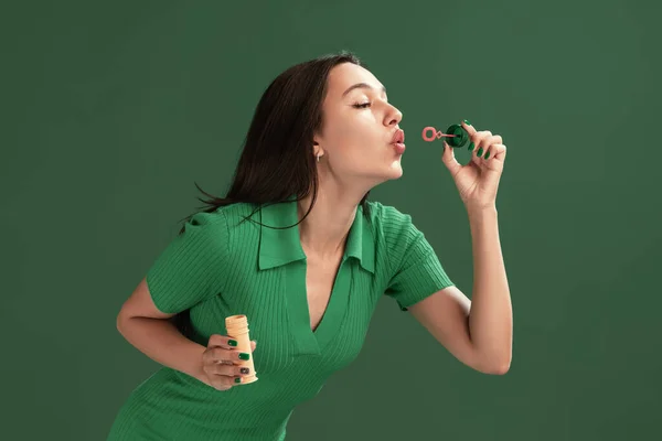 Portrait Beautiful Young Girl Posing Blowing Soap Bubbles Isolated Green — 图库照片