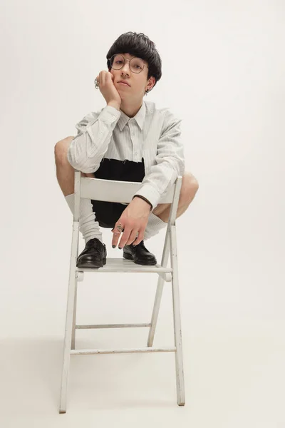 Portrait Stylish Young Boy Piercing Sitting Chair Calm Dreamy Look — Zdjęcie stockowe