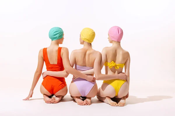 Back View Portrait Three Young Women Sitting Colorful Swimming Suit — Fotografia de Stock