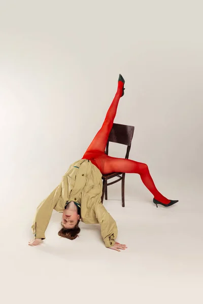 Portrait Young Girl Red Tights Stylish Jacket Posing Falling Chair — Stockfoto