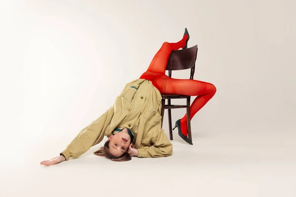 Portrait Young Girl Red Tights Stylish Jacket Posing Falling Chair — 图库照片