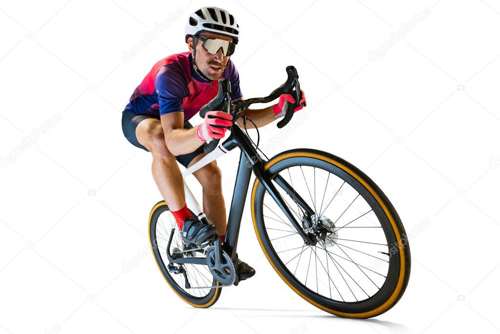 Portrait of man, professional cyclist training, riding isolated over white studio background. Concentration. Concept of sport, action, motion, speed, hobby, lifestyle. Copy space for ad