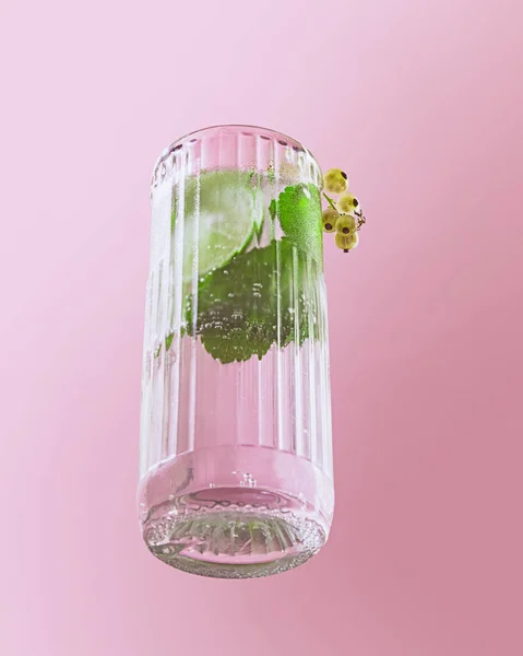 Glass of chill sparkling water, mojito cocktail with fresh mint, lime and rom isolated on pink background. Popular drink. Concept of alcoholic drinks, taste, party, mix. Copy space for ad. Retro style
