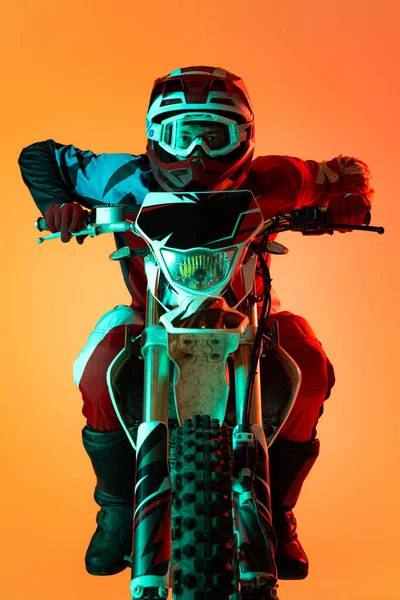 Portrait Young Concentrated Man Biker Developing Speed Motorbike Isolated Orange — Stockfoto