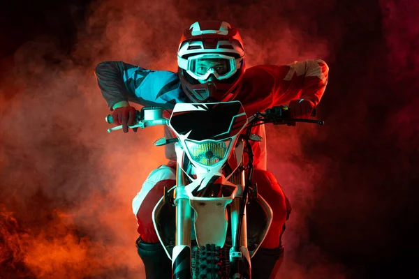 Young Concentrated Man Biker Developing Speed Motorbike Isolated Dark Background — Fotografia de Stock