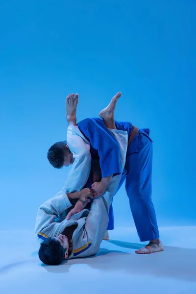 Portrait Judo Athletes Training Practising Throws Isolated Blue Background Neon — Stock Fotó