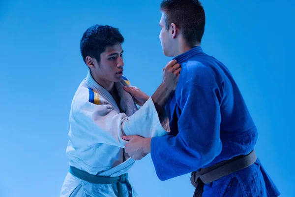 Portrait Two Professional Judo Athletes Training Fighting Isolated Blue Studio — ストック写真