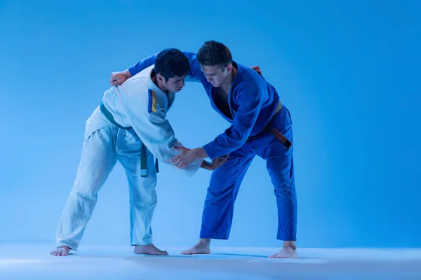 Portrait Professional Judo Athletes Training Isolated Blue Studio Background Neon — Stockfoto