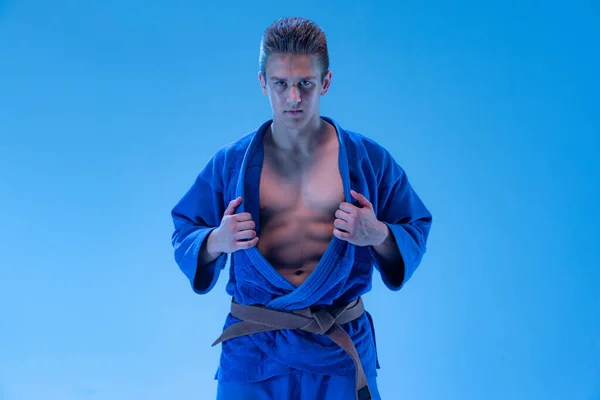 Portrait Young Sportive Man Blue Kimono Posing Isolated Blue Background — Fotografia de Stock