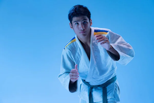 Portrait Young Sportive Man Training Judo Isolated Blue Background Neon — Stockfoto
