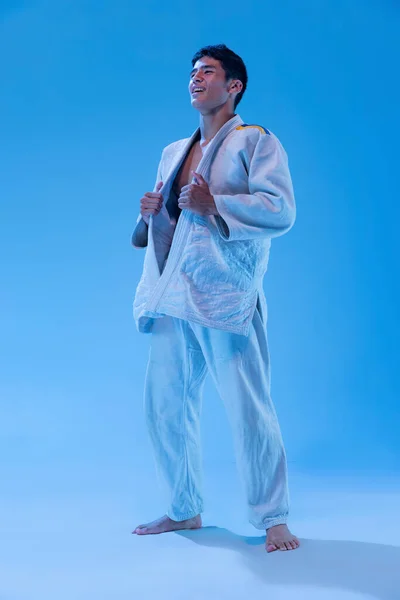 Portrait Young Sportive Man Cheerfully Posing White Kimono Isolated Blue — Zdjęcie stockowe
