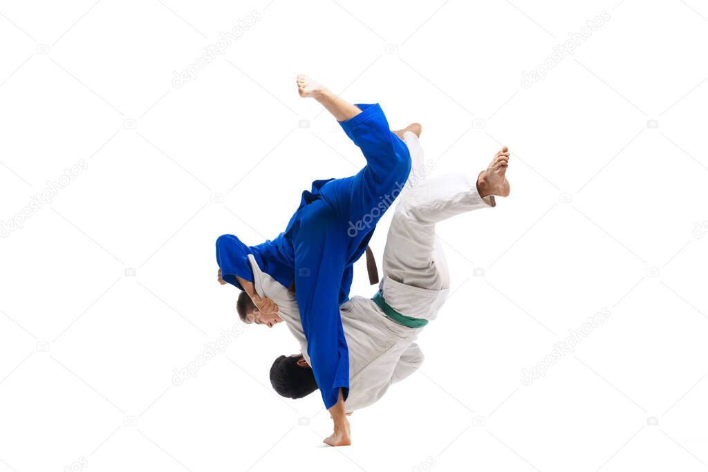 Portrait of two sportive men, professional martial arts fighters training isolated over white background. Concept of martial art, combat sport, health, strength, energy, fit. Copy space for ad