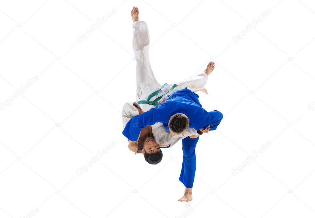 Portrait of two professional martial arts fighters training isolated over white background. Coach and trainee. Concept of martial art, combat sport, health, strength, energy, fit. Copy space for ad