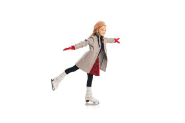Portrait of stylish little girl, child posing, skating isolated over white studio background. Sportive lifestyle. Concept of childhood, friendship, fun, lifestyle, fashion. Retro style