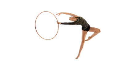 Portrait of young girl, female rhytmic gymnast training with hoop isolated over white studio background. Flexibility. Concept of action, motion, sport life, motivation, competition. Copyspace for ad