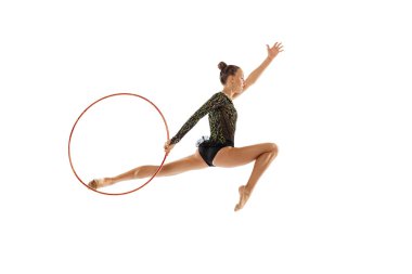 Portrait of young sportive girl, female rhytmic gymnast performing with hoop isolated over white studio background. Concept of action, motion, sport life, motivation, competition. Copyspace for ad