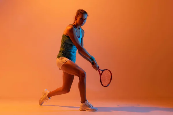 Concentrated Woman Professional Tennis Player Training Isolated Orange Studio Background — Stock Fotó