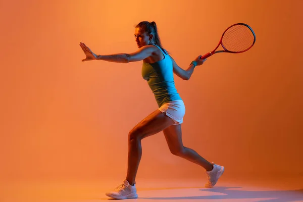 Portrait Concentrated Woman Professional Tennis Player Returning Ball Isolated Orange — Photo