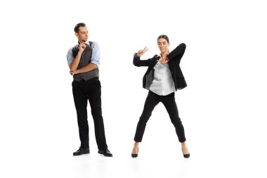 Portrait of young man and woman, office workers in official clothes isolated on white background. Cheerful woman dancing. Concept of business, office lifestyle, success, ballet, career, expression, ad