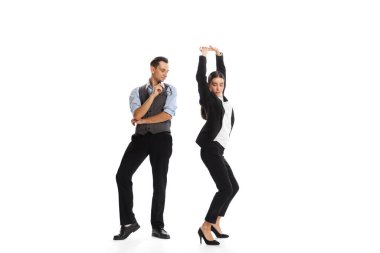 Portrait of two business people, office worker posing on white background. Man watching hoe woman dancing. Celebration. Concept of business, office lifestyle, success, ballet, career, expression, ad
