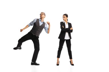 Portrait of man, office manager cheerfully dancing near woman, employee isolated over white background. Successful job. Concept of business, office lifestyle, success, ballet, career, expression, ad