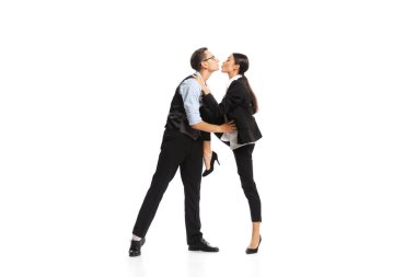 Portrait of two employees, managers in official suit kissing isolated over white background. Office romance. Concept of business, office lifestyle, success, ballet, career, expression, ad