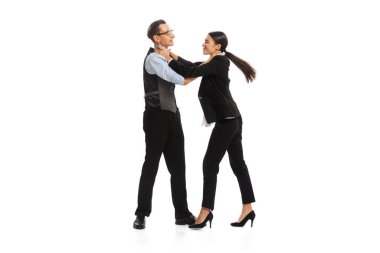 Portrait of man and woman, office managers, employees fighting with each other isolated on white background. Concept of business, office lifestyle, success, ballet, career, expression, ad