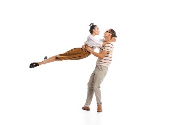 Portrait of stylish man and woman in retro outfit posing together isolated over white studio background. Romance. Concept of business, office lifestyle, success, ballet, career, expression, ad