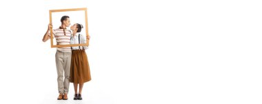 Portrait of man and woman posing together in a picture frame, kissing isolated over white background. Retro style.. Family look. Concept of fashion, relationship, creativity, business, expression, ad