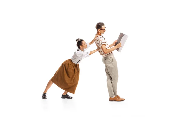 Portrait Young Woman Pushing Man Reading Newspaper Isolated White Background — Stockfoto