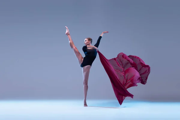 Portrait Young Flexible Ballerina Dancing Deep Red Fabric Isolated Blue — Fotografia de Stock