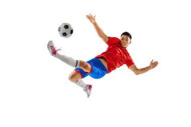 Portrait of young man, football player in motion, training, kicking ball in jump isolated on white studio background. Final winning goal. Concept of sport, team game, action, motion. Copy space for ad