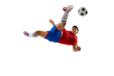 Portrait of professional football player training, kicking ball in a jump isolated over white studio background. Concept of sport, team game, action, motion. Copy space for ad, poster