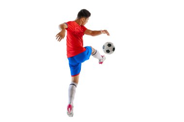 Dynamic portrait of young man, football player in motion, kicking ball isolated over white studio background. Forward position. Concept of sport, team game, action, motion. Copy space for ad, poster