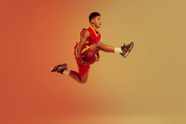 Portrait Young Man Basketball Player Motion Jumping Training Isolated Orange — Foto Stock