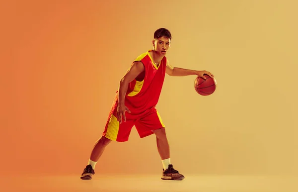 Portrait Young Man Basketball Player Training Isolated Orange Studio Background — Stockfoto