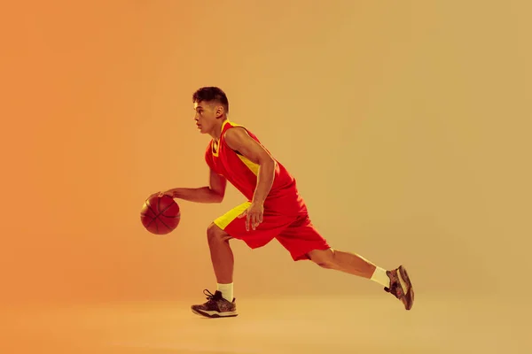 Portrait Young Man Basketball Player Training Dribbling Isolated Orange Studio — Stock fotografie