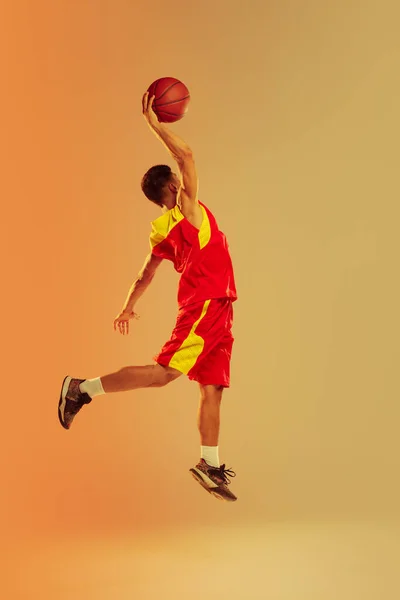 Portrait Young Man Basketball Player Isolated Orange Studio Background Neon — Stock Fotó